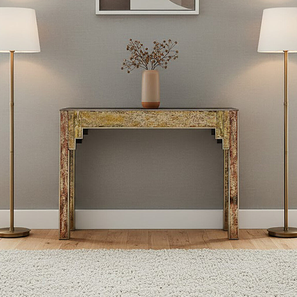 Console table with a vase of flowers between two floor lamps in a room.
