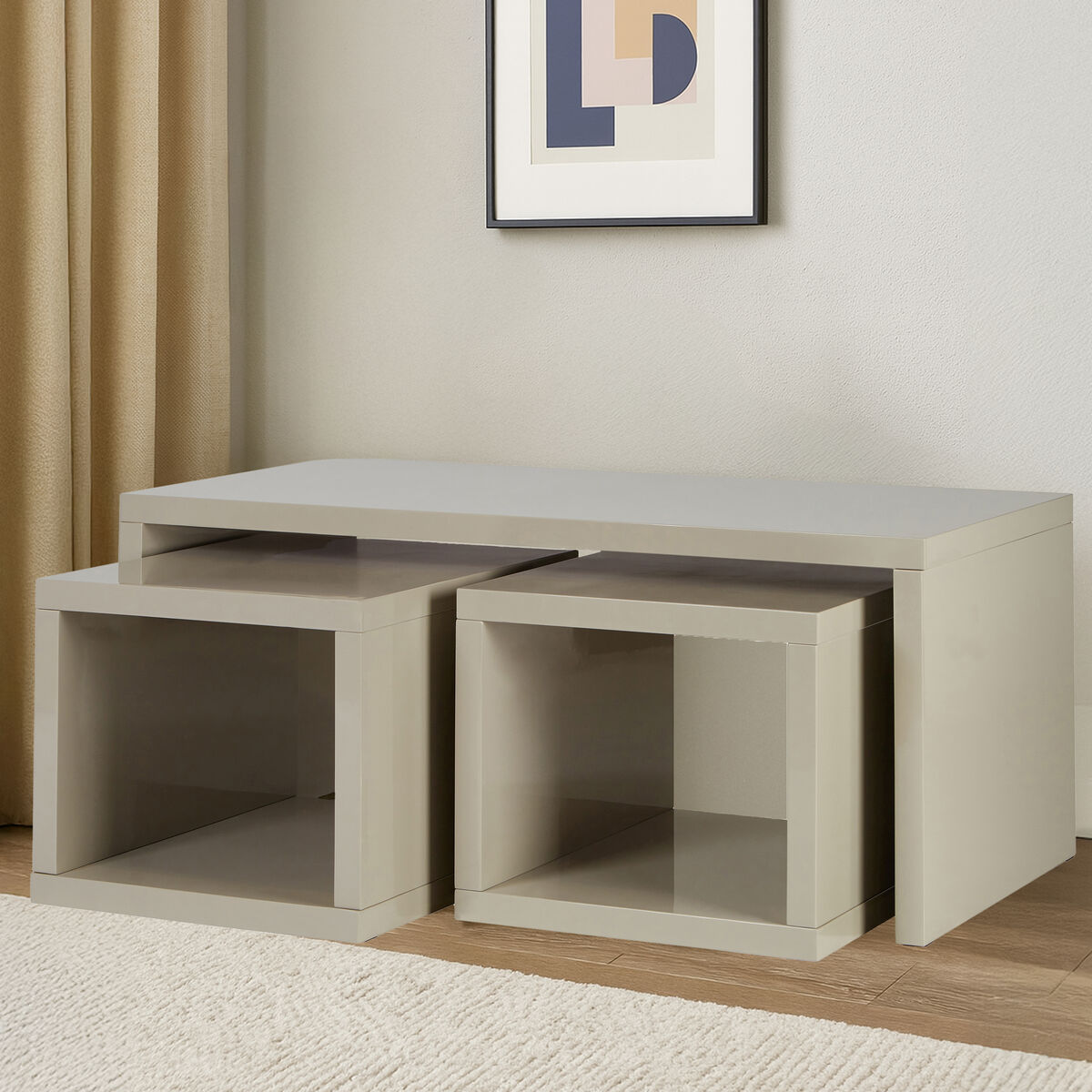 Set of three nesting tables in a room with a framed picture on the wall.