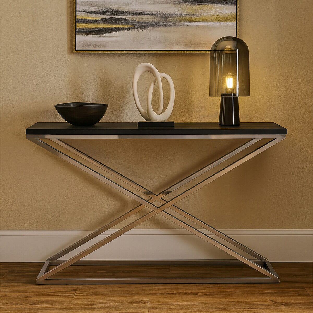 Modern console table with decorative items against a beige wall.