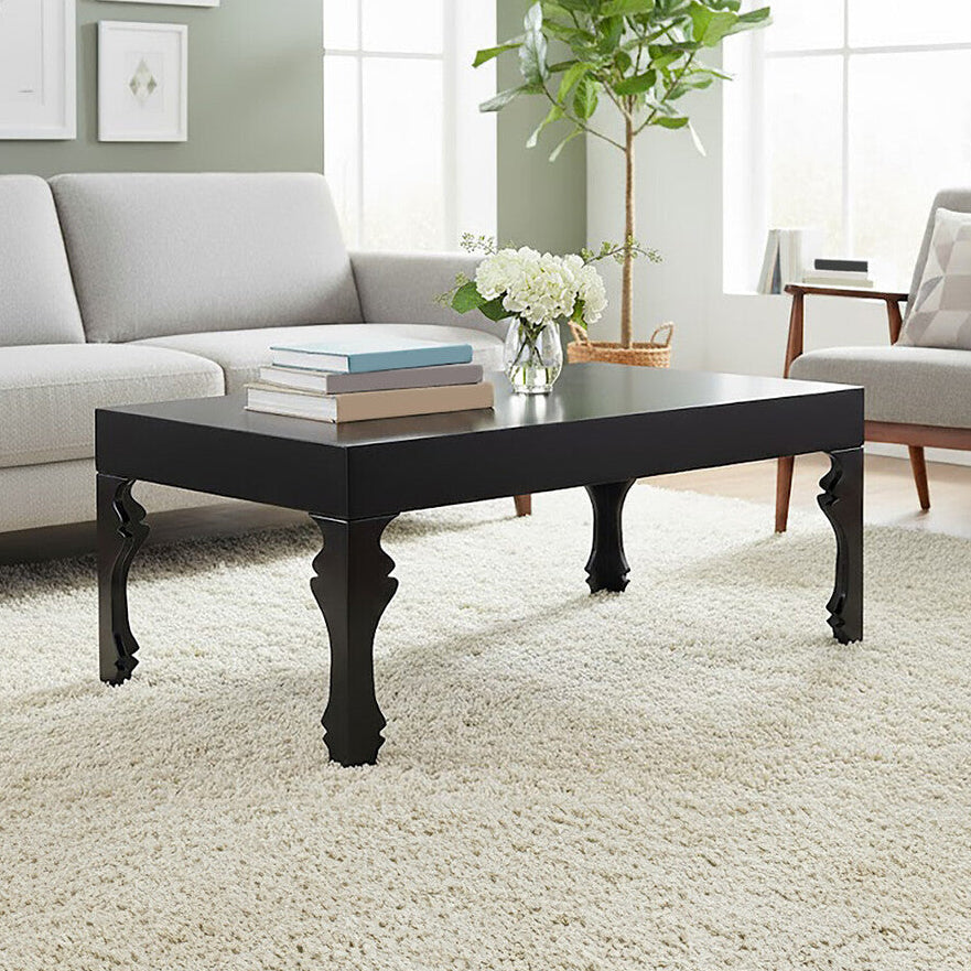 Living room with a black coffee table, gray sofa, and armchair.