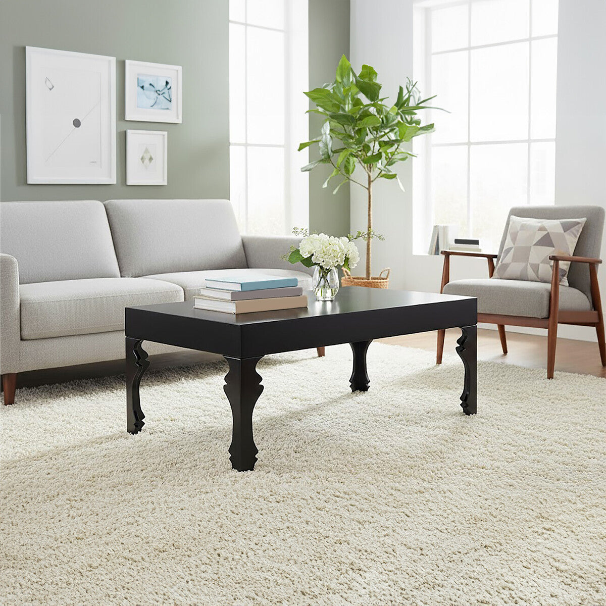 Living room with a black coffee table, gray sofa, and armchair.