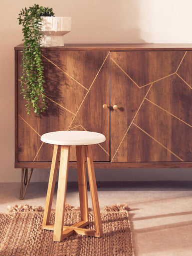 Wooden cabinet with geometric design and a stool in front, on a neutral background
