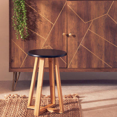 Wooden cabinet with geometric design and a black stool in front