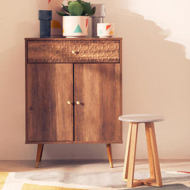 Wooden cabinet with decorative items and a stool in a room setting