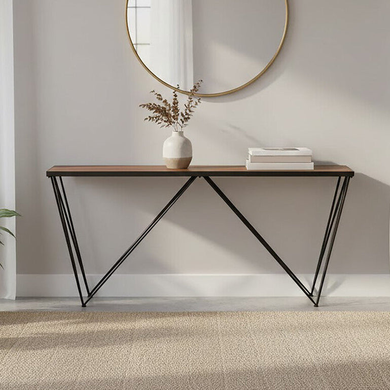 Modern interior with a round mirror, console table, and plants.