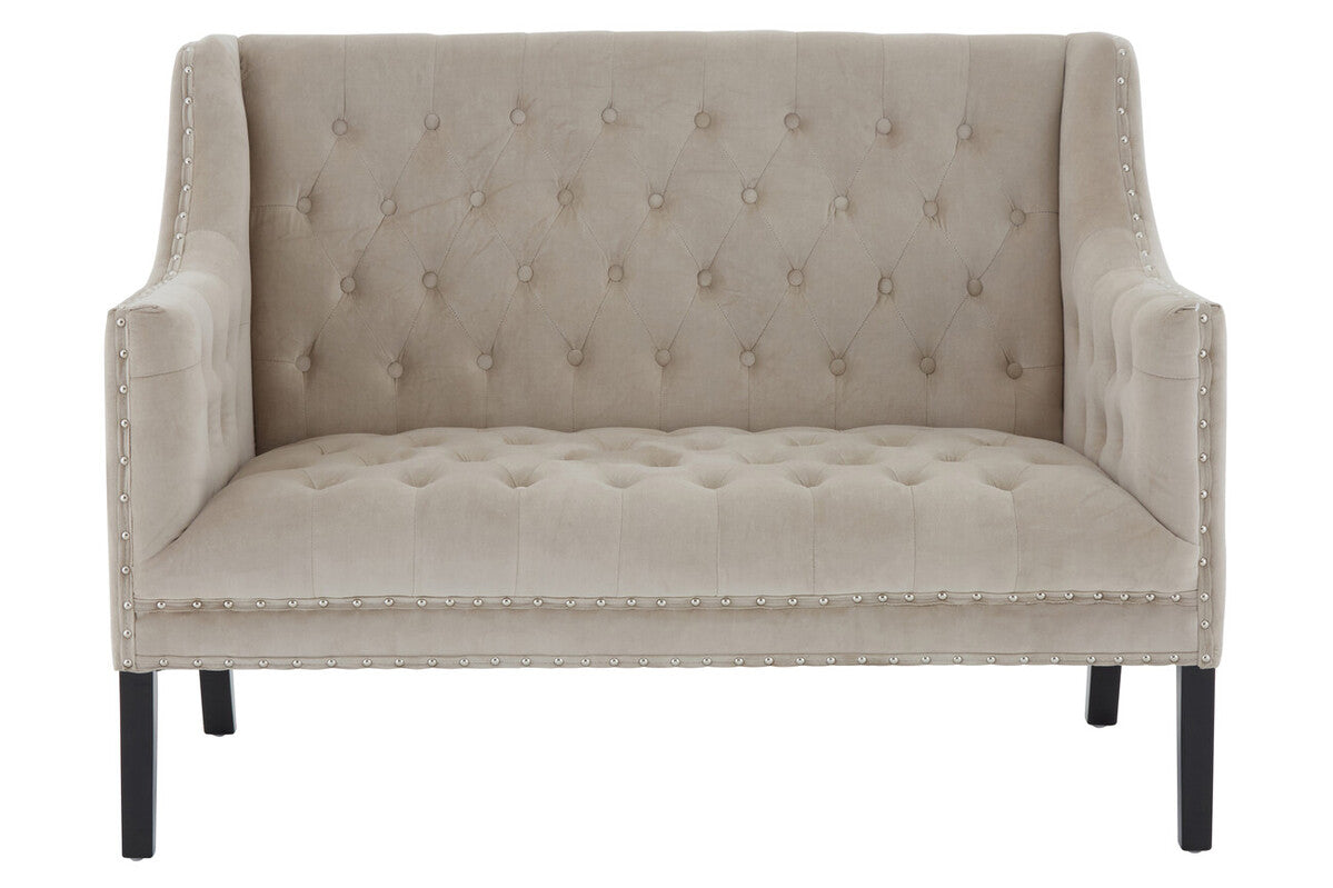 Beige tufted loveseat with nailhead trim on a white background