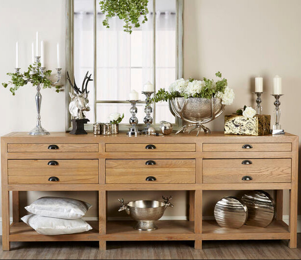Wooden sideboard with decorative items in a room setting