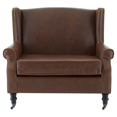 Brown leather armchair with decorative nailhead trim on a white background