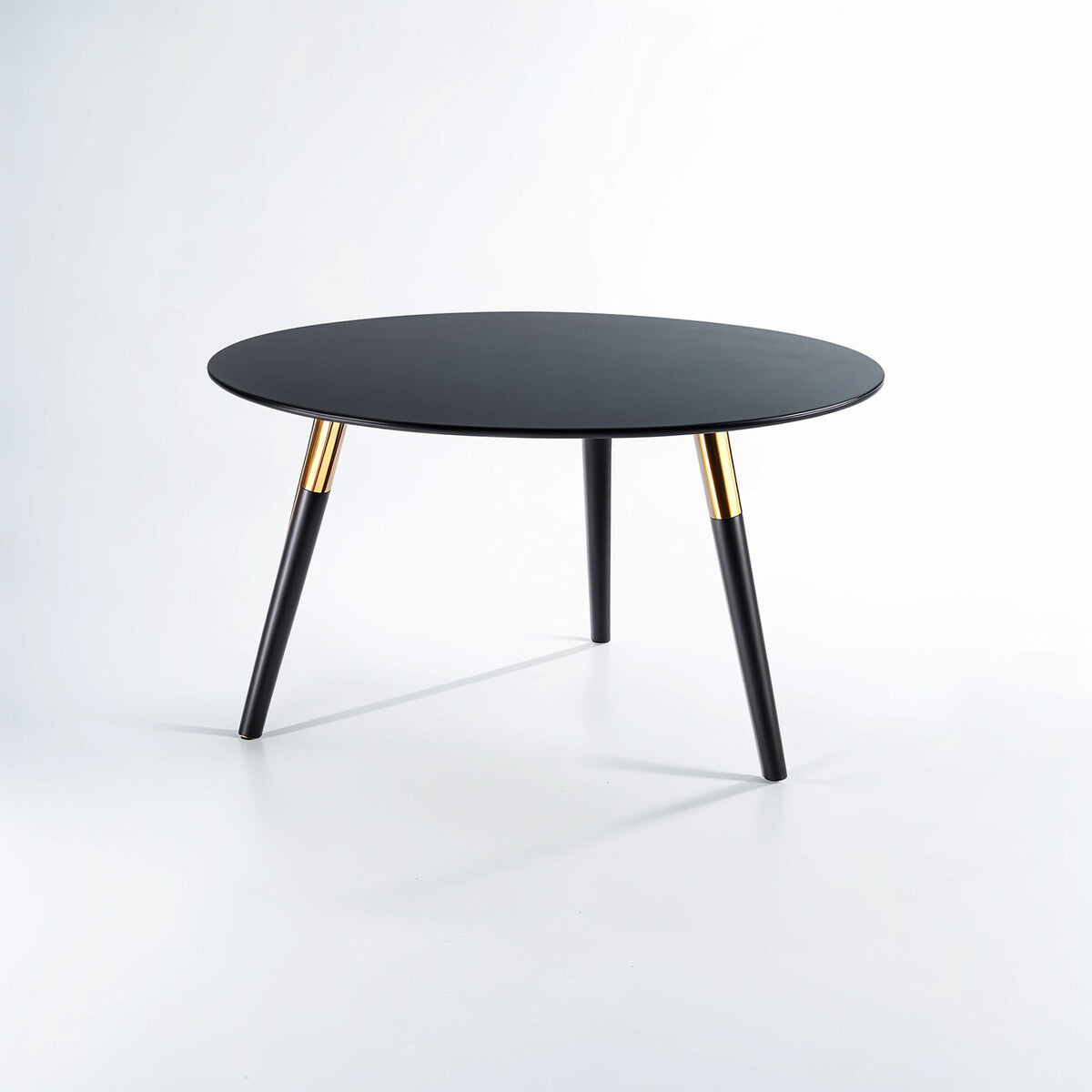 Black round table with gold accents on a white background