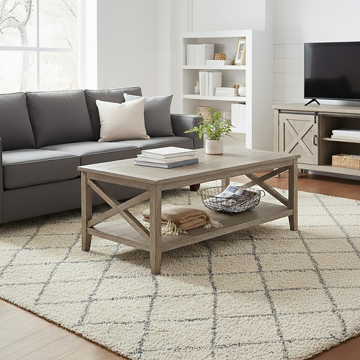Living room with a gray sectional sofa, wooden coffee table, and a TV stand.