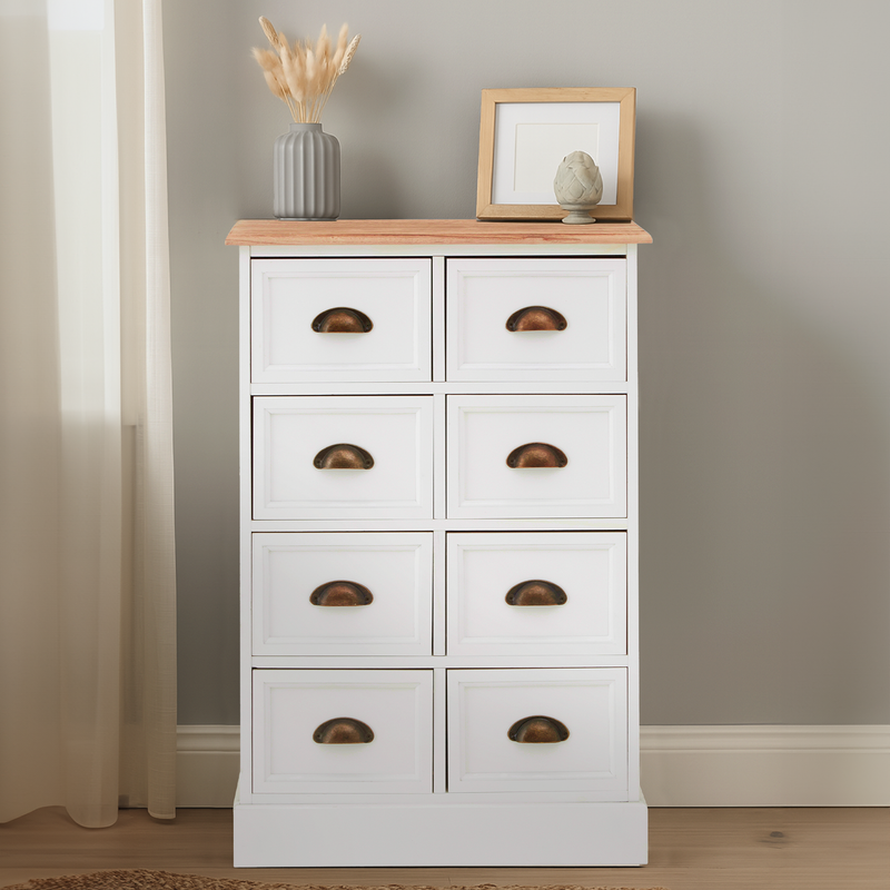 White dresser with wooden top against a neutral wall