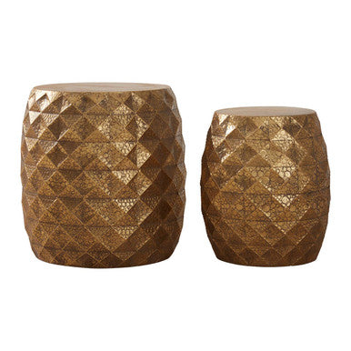 Two gold textured stools on a white background