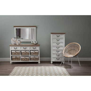 Rustic-style bedroom furniture set with dresser, mirror, and chair against a gray wall.