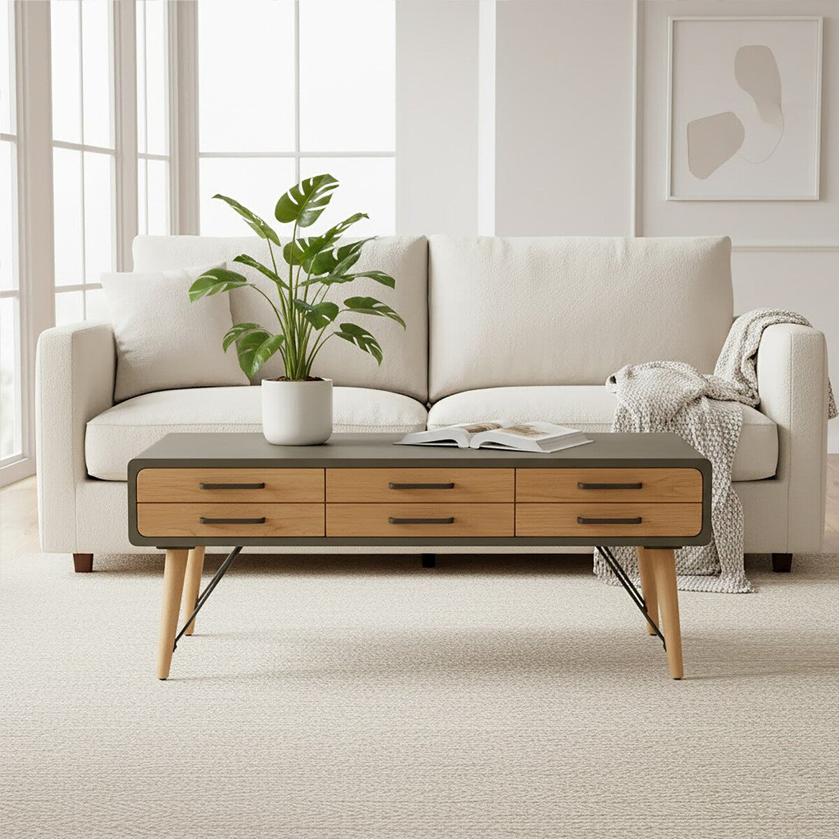 Modern living room with a beige sofa, wooden coffee table, and plant.