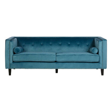 Blue sofa with tufted backrest and nailhead trim on a white background