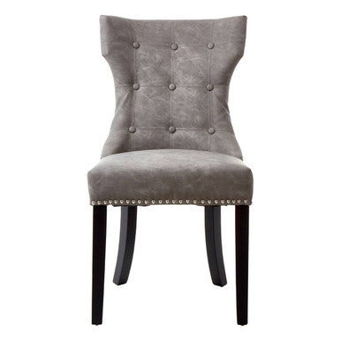 Gray upholstered chair with button tufting and black legs on a white background
