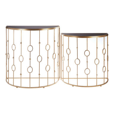 Set of two gold metal side tables with circular patterns on a white background