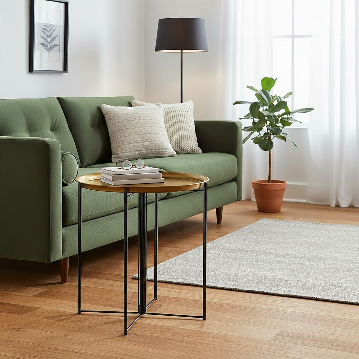 Modern living room with green sofa, side table, and plant