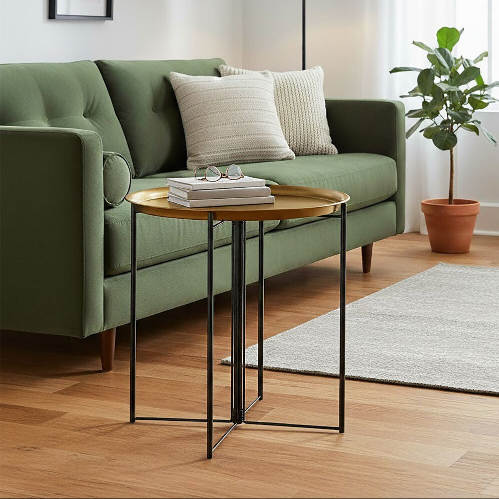 Modern living room with green sofa, side table, and plant