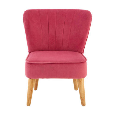 Pink velvet chair with wooden legs on a white background
