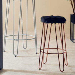 Two bar stools with metal frames and cushioned seats in a room with a plant and window.