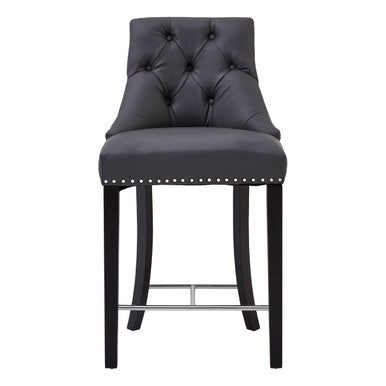 Black bar stool with tufted seat and nailhead trim on a white background
