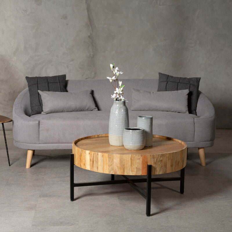 Gray sofa with wooden coffee table in a minimalistic room