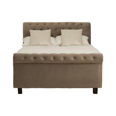 Beige upholstered bed with tufted headboard and decorative pillows on a white background