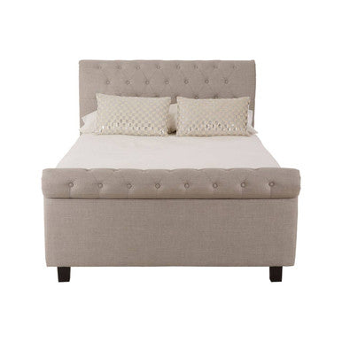 Beige upholstered bed with white mattress and pillows on a white background