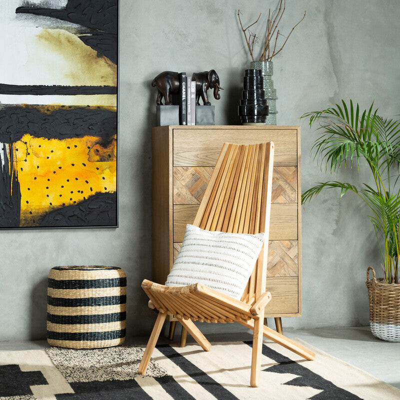 Modern interior with wooden chair, cabinet, and abstract painting on a gray wall.