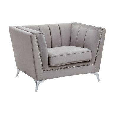 Gray upholstered chair with nailhead trim on a white background
