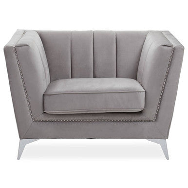 Gray armchair with tufted backrest and nailhead trim on a white background