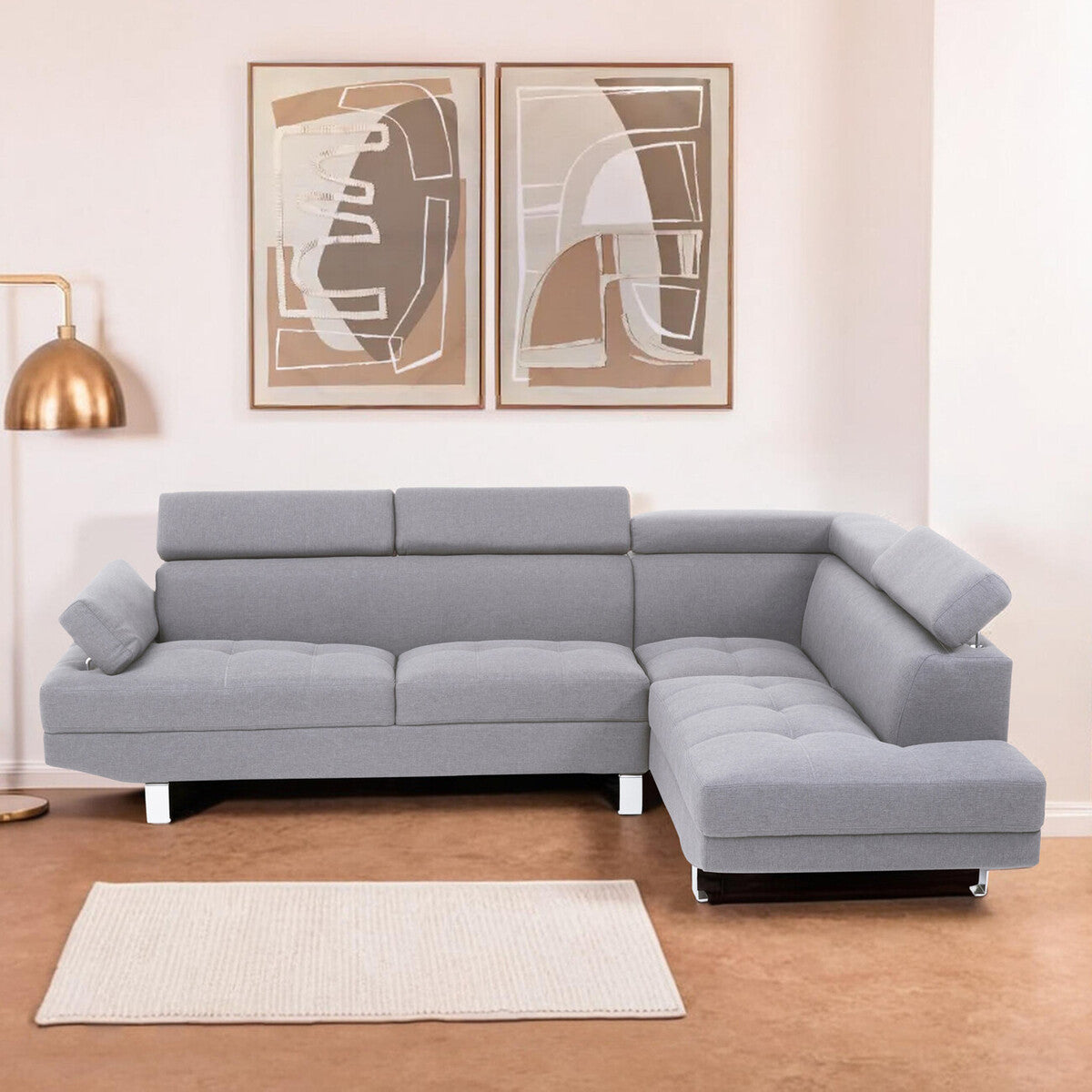 Gray sectional sofa in a living room with abstract art on the wall.
