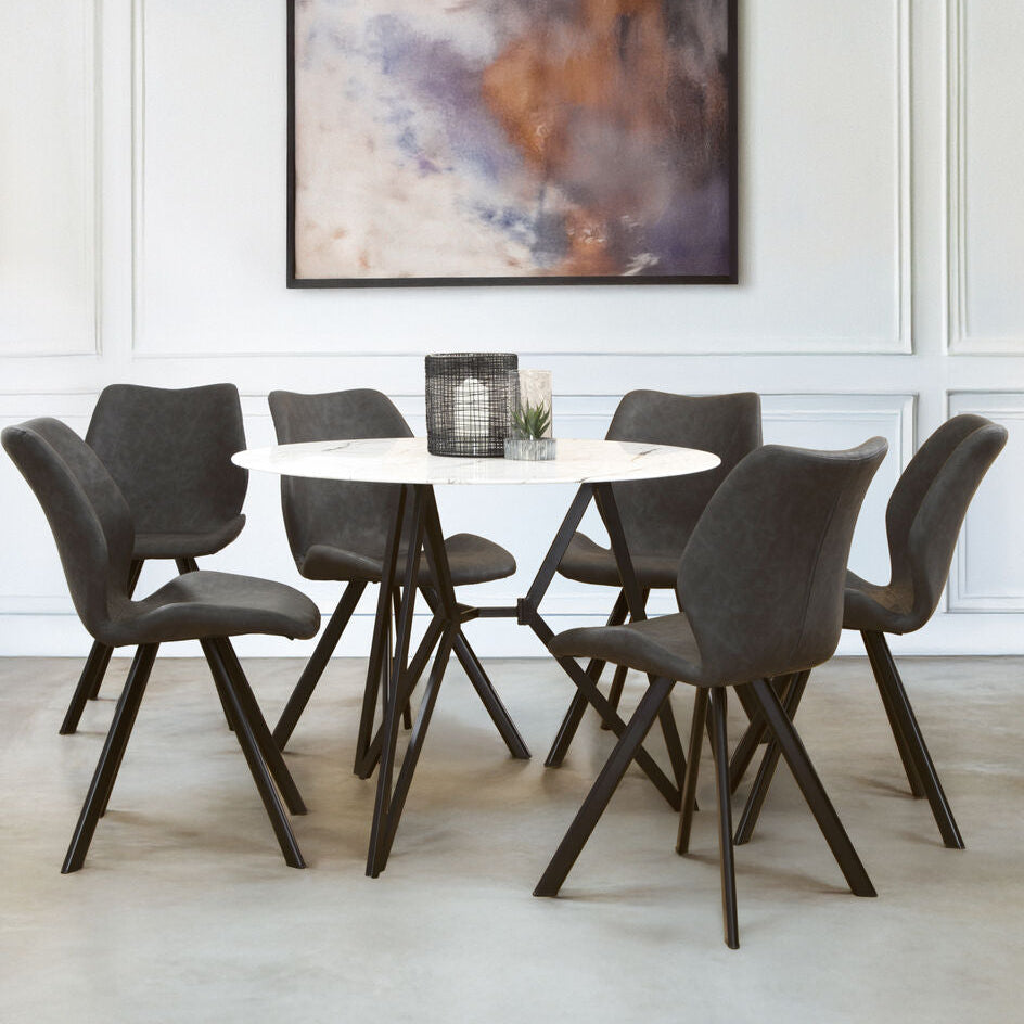 Dining room with a round table and six chairs in a modern interior setting.
