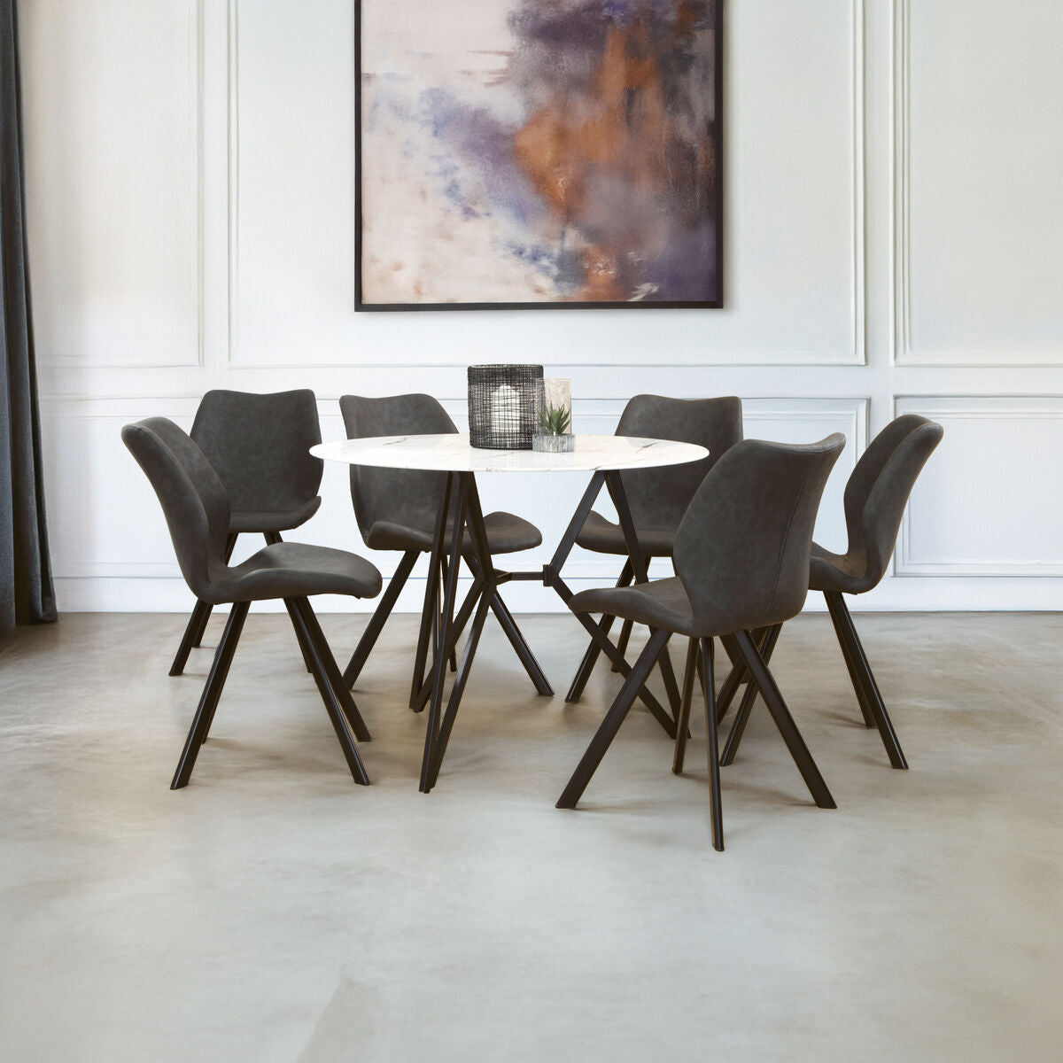 Dining room with a round table and six chairs in a modern interior setting.