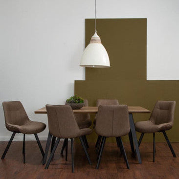 Dining area with brown chairs and a wooden table against a green wall.