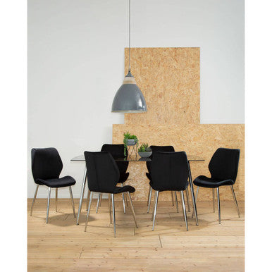 Modern office setting with black chairs around a table against a light gray wall.