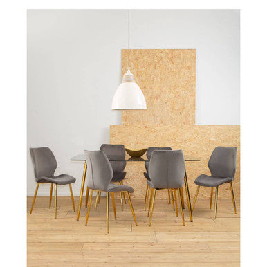 Dining area with gray chairs and a white pendant light on a wooden floor.