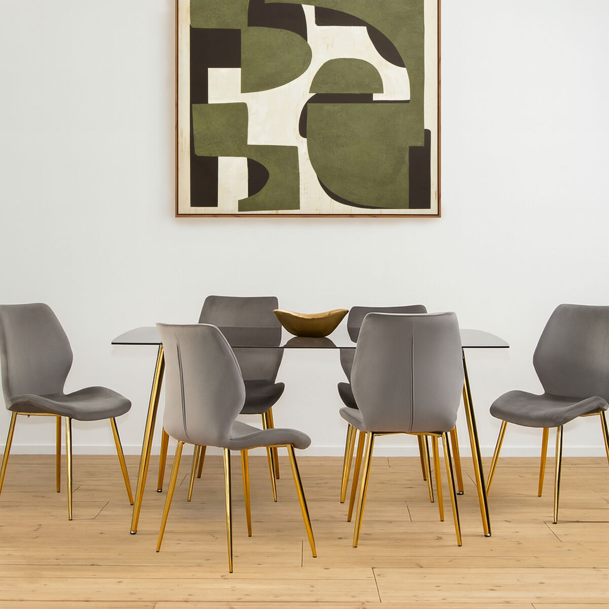Dining room with a glass table and gray chairs, featuring a modern abstract painting on the wall.