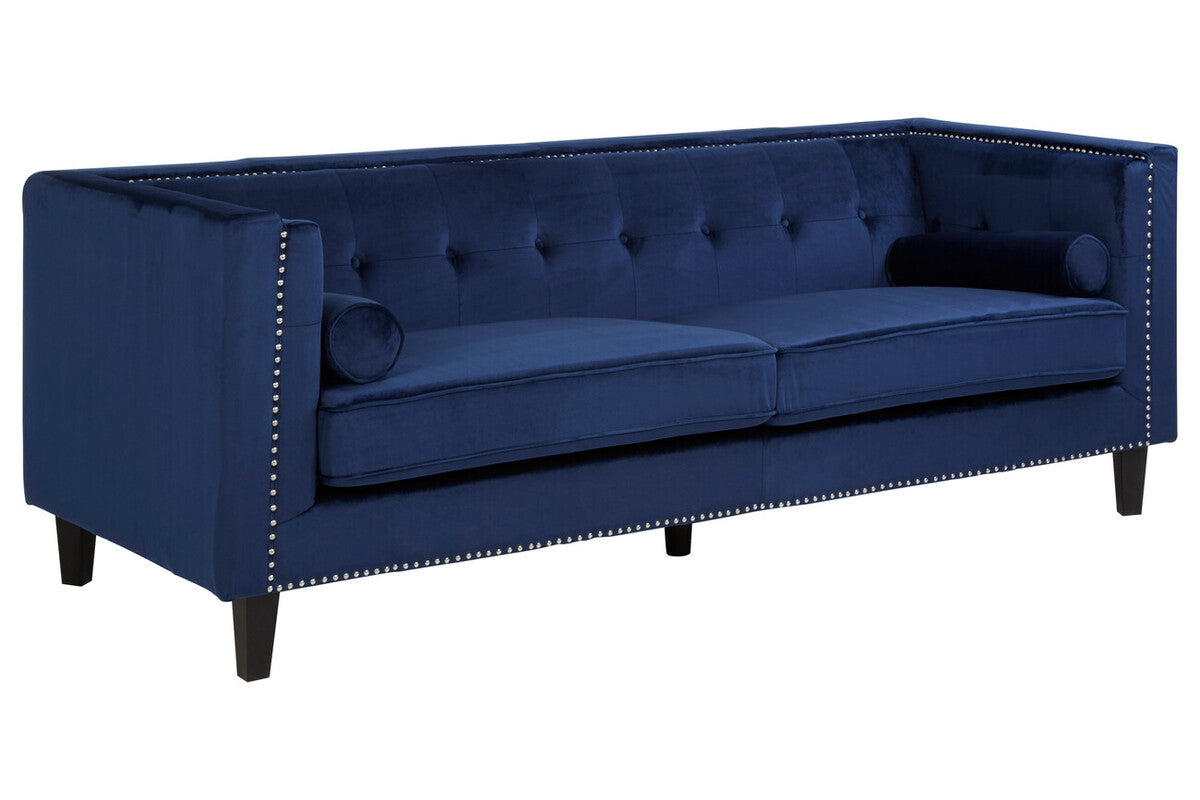 Blue tufted sofa with nailhead trim on a white background
