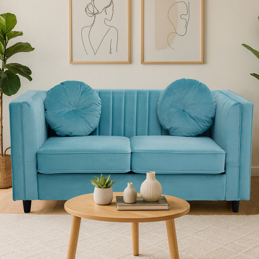 Blue sofa with decorative pillows in a living room setting