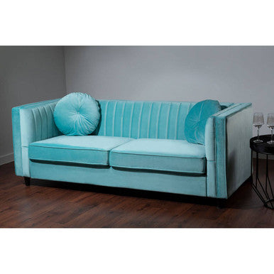 Turquoise sofa with decorative pillows in a room setting.
