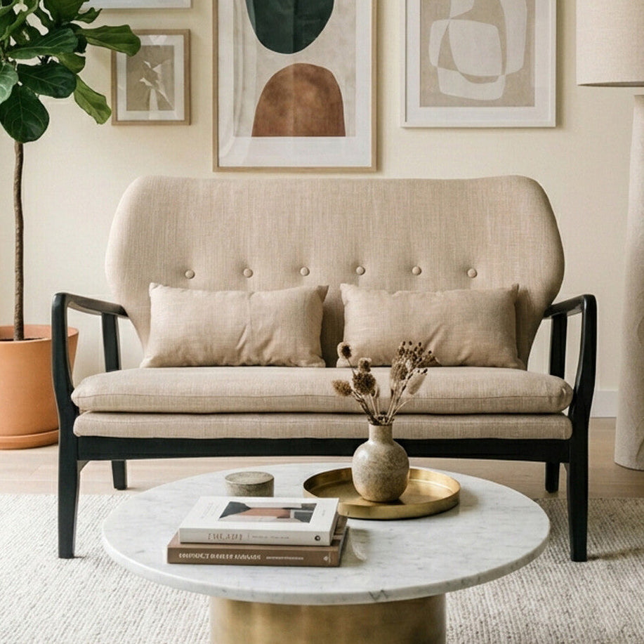 Living room with beige sofa, marble coffee table, and abstract art on the wall.