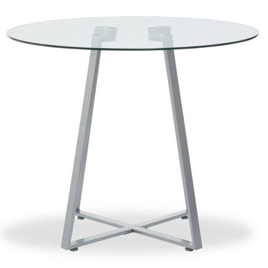 Round glass table with metal legs on a white background