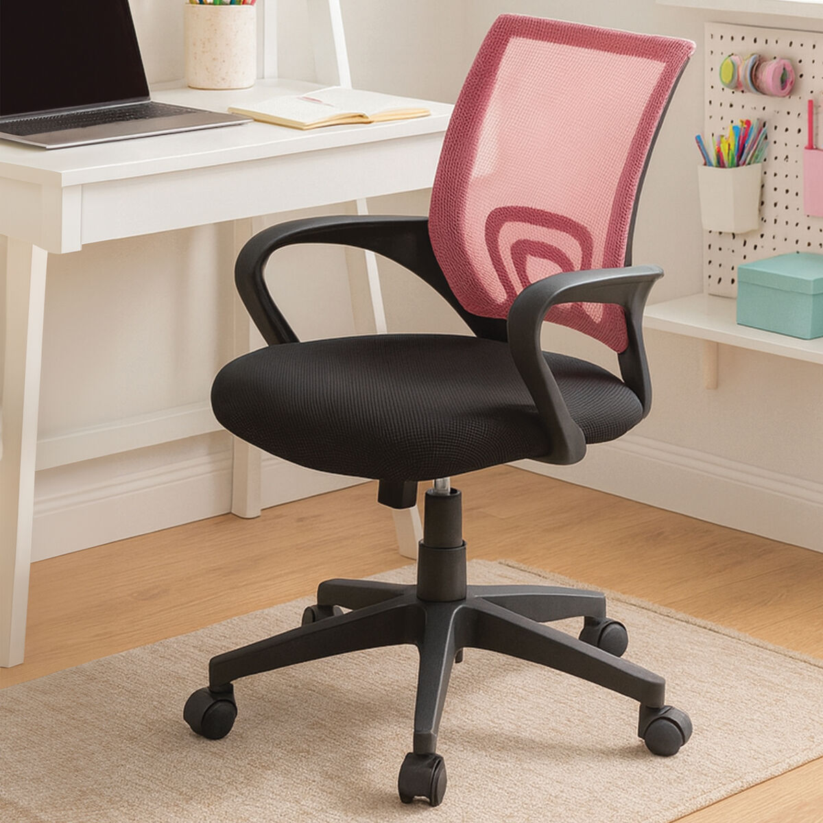Black office chair with pink mesh backrest in a home office setting.