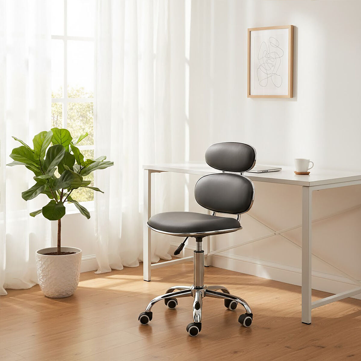 Black office chair in a bright room with a desk and plant