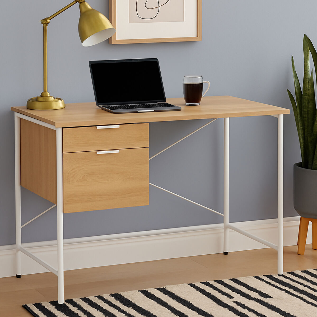 Wooden desk with laptop, lamp, and cup in a home office setting