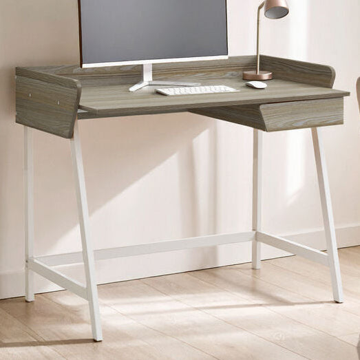 Modern desk with computer setup in a bedroom