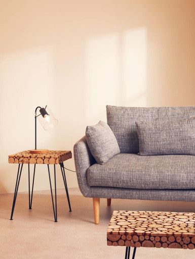 Gray sofa in a living room with a side table and coffee table.