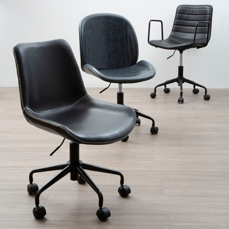 Three black office chairs on a wooden floor with a white wall background